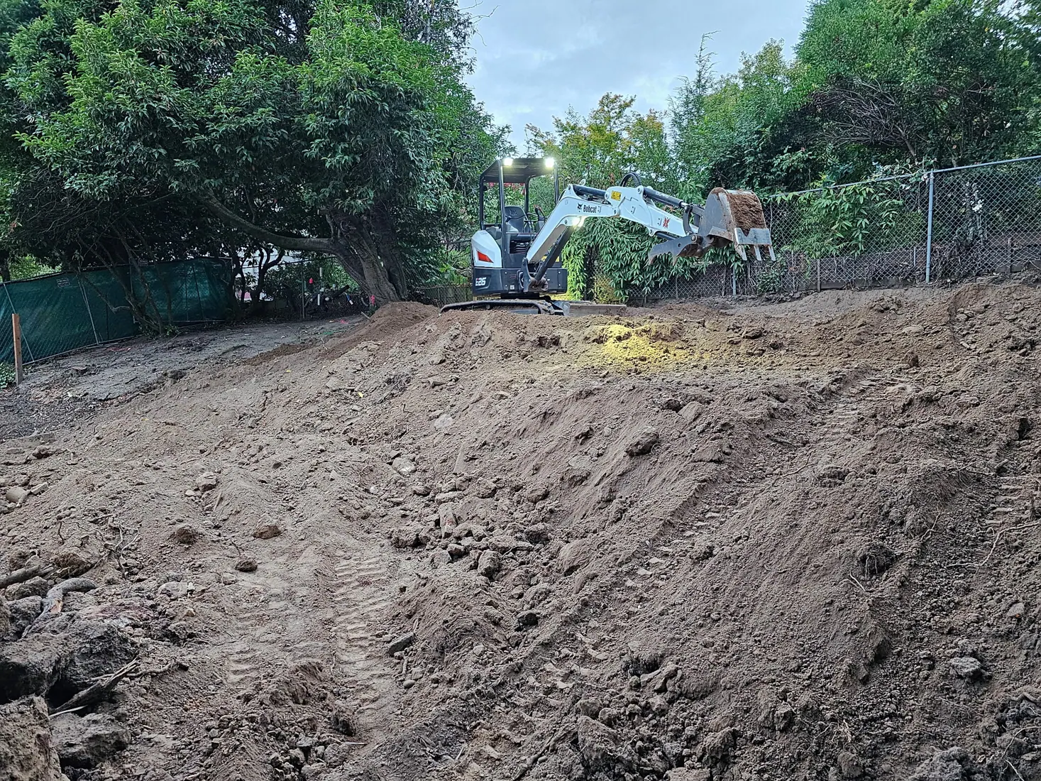 Bobcat excavator moving soil